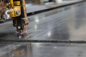 Metal sheets and tools in a fabrication workshop.