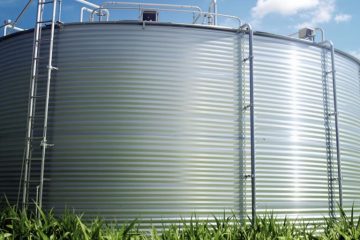 Photograph of a sturdy steel water tank outdoors.